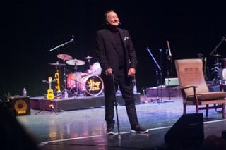 Duncan Norvelle performing on stage after suffering stroke
