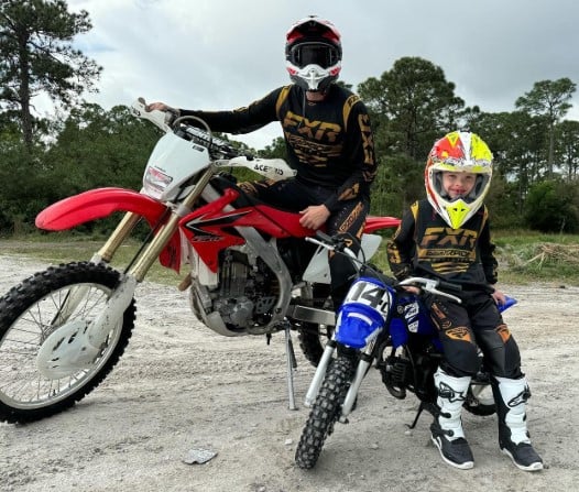 Eric Luke Trump while riding a bike with his father