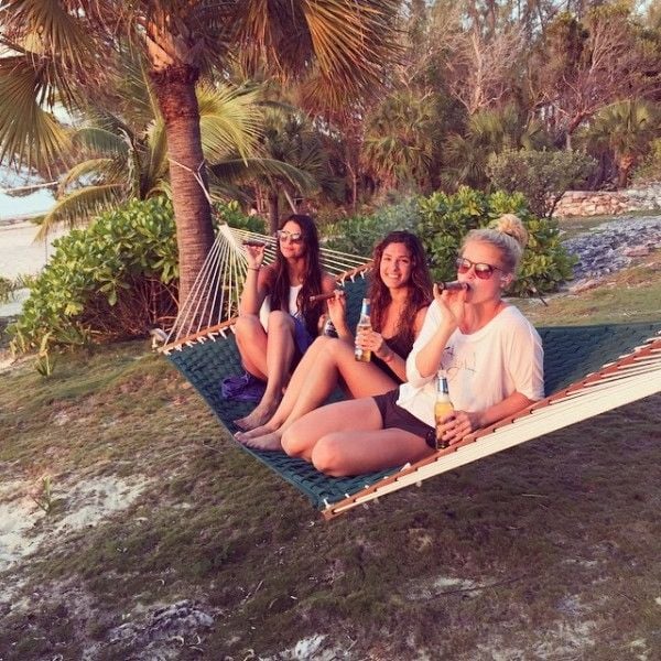 Erika Hammond (left) while smoking a cigar with friends