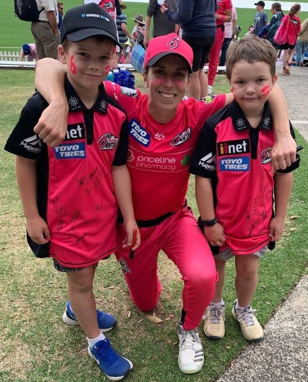 Erin Burns with two Sydney Sixers fans