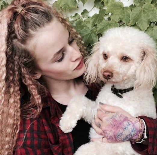 Esther McGregor posing with her pet dog