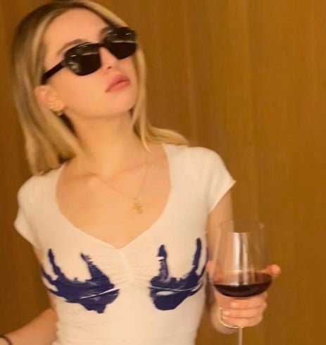 Eve Jobs while enjoying wine