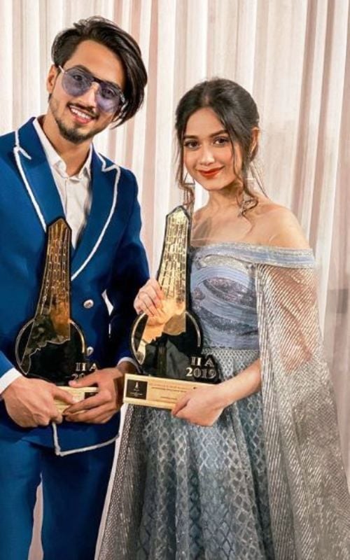 Faisal Shaikh Posing with His Award