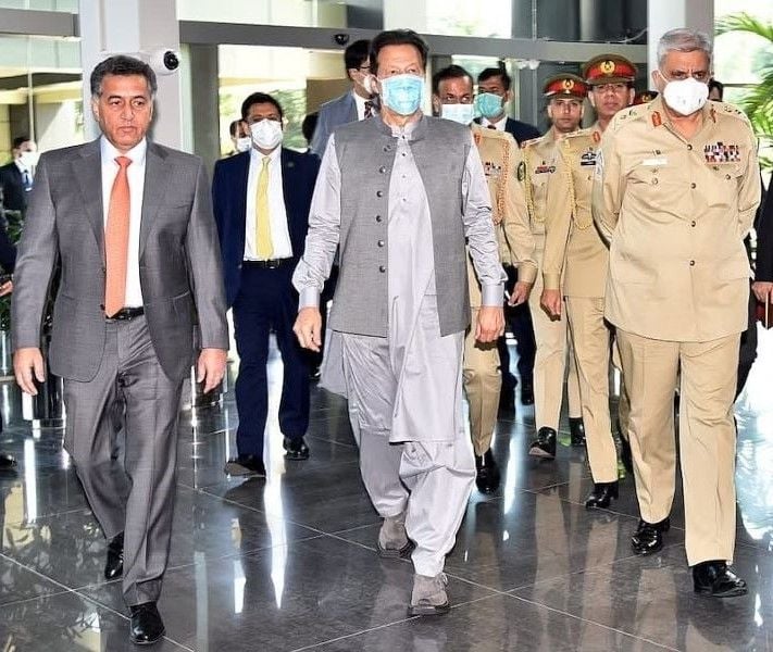 Faiz Hameed (left) with Imran Khan (centre)