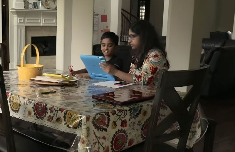 Faizan Zaki learning and practising words with his mother