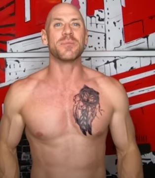Fake wolf tattoo on left chest of Johnny Sins