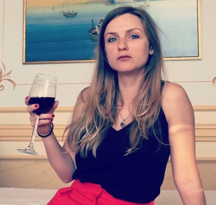 Faye Marsay holding a glass of wine