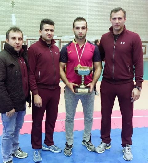 Fazel Atrachali (holding the trophy) after winning the Iran Champions League