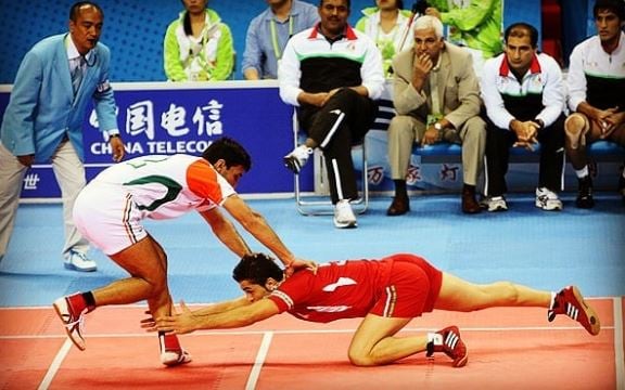 Fazel Atrachali (in red) during the final against India in 2010 Asian Games