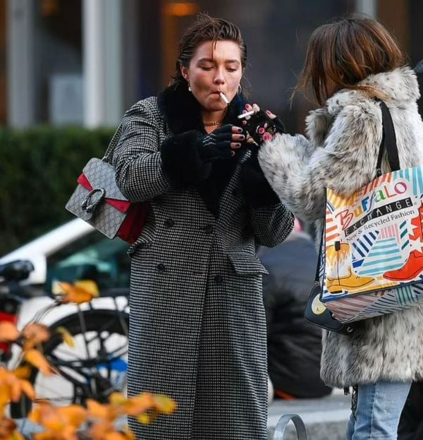 Florence Pugh while lighting up a cigarette