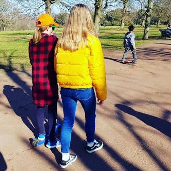 Frances and Liberty being photographed from the back by their mother, Liz Truss