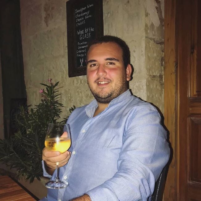 Gabriel Muscat holding a glass of alcohol