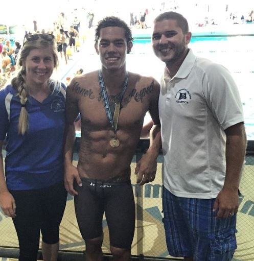 Gabriel Yoshimoto (center) after winning a medal in a swimming competition