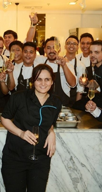 Garima Arora holding a glass of wine