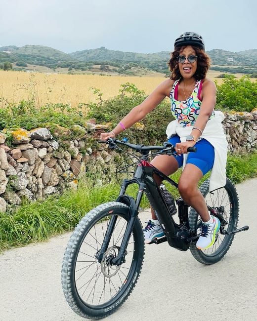 Gayle King riding a bicycle