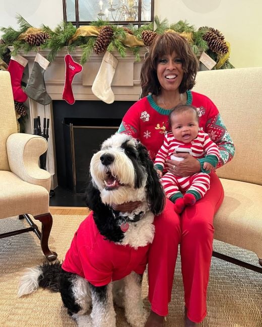Gayle King sitting next to her Sheepadoodle