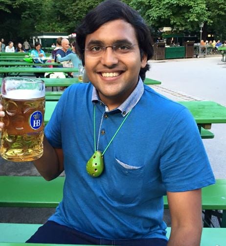 Gopi Thotakura holding a glass of beer
