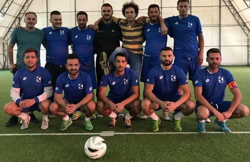 Gramos Bajcinovci (sitting, extreme right) after winning a soccer amateur game while working in Klan Kosova