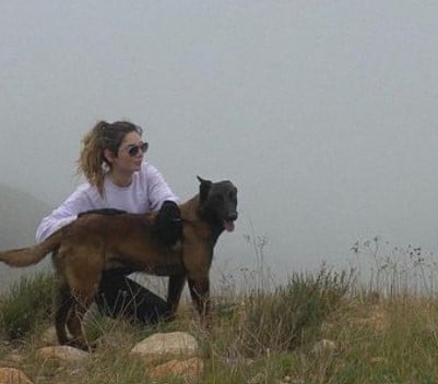 Grecia Muñoz posing with her pet dog