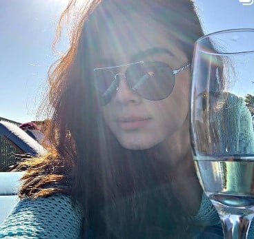 Grecia Muñoz while enjoying white wine