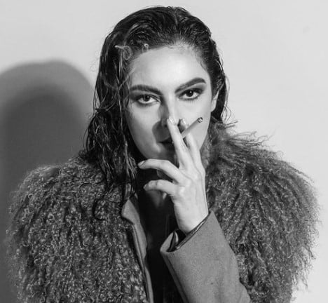 Grecia Muñoz while smoking a cigarette