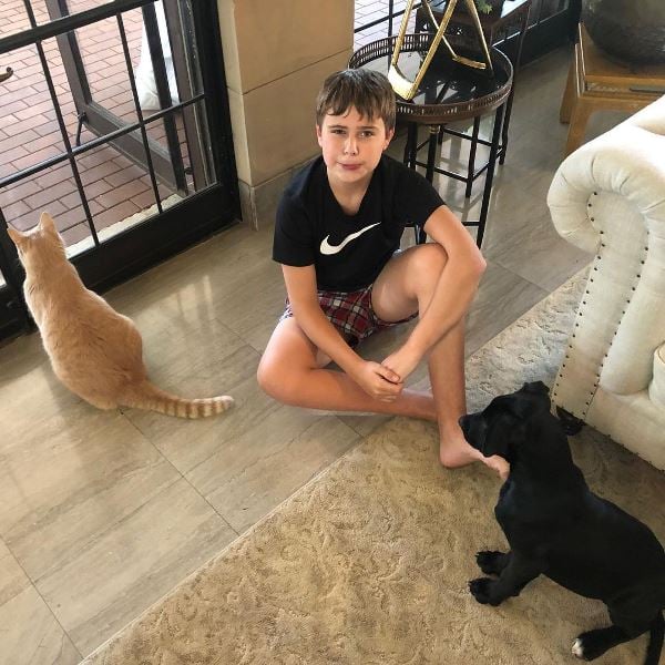 Gus Walz siting with his dog and cat