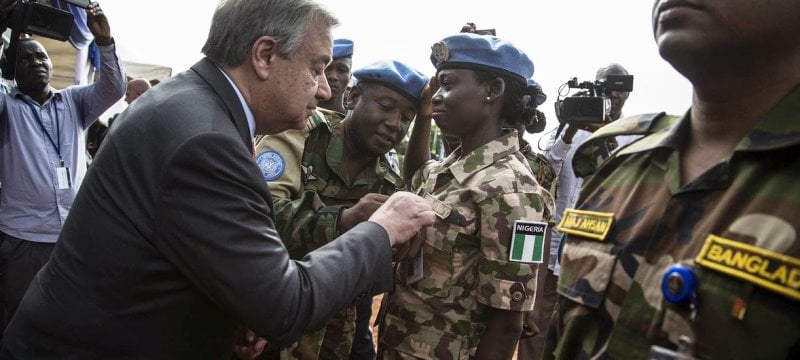 Guterres pinning a medal on a female UN peacekeeper serving in Africa