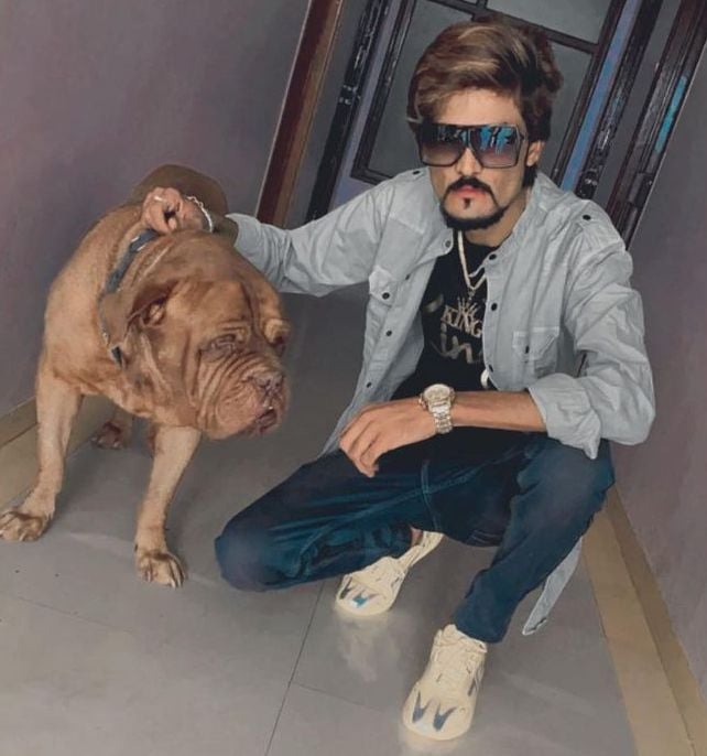Haji Ali Agariya posing with his pet dog