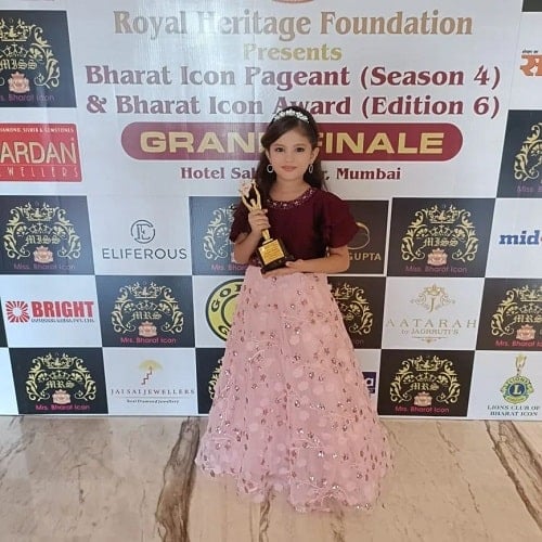 Hardika Sharma with her trophy in a beauty pageant
