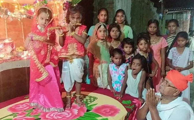 Hare Ram Pandey and some orphaned girls during a program at the ashram