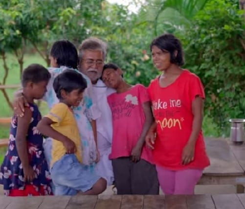 Hare Ram Pandey posing with his adopted daughters