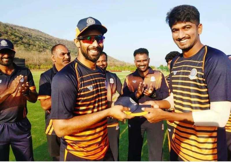 Harishankar receiving his Vijay Hazare Trophy debut cap from Hanuma Vihari