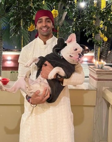 Harman Virk posing with his pet dog
