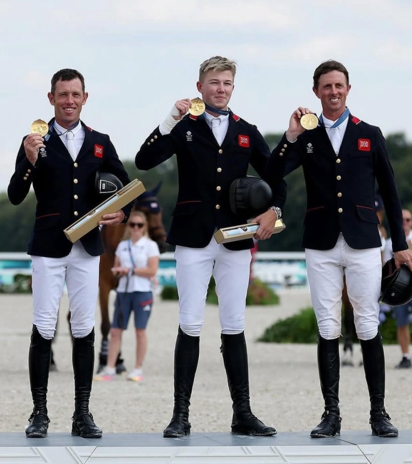 Harry Charles (middle) with Scott Brash (right), and Ben Maher (Left) after winning the gold medal at the Paris Olympics 2024