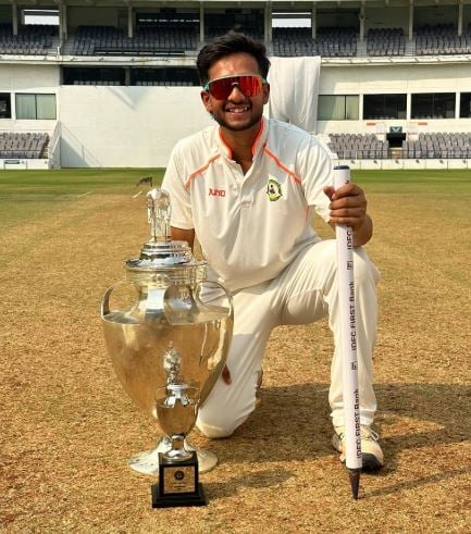 Harsh Dubey posing with Ranji trophy
