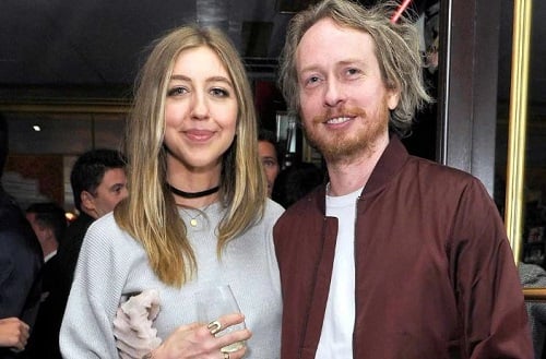 Heidi Gardner holding a glass of alcohol