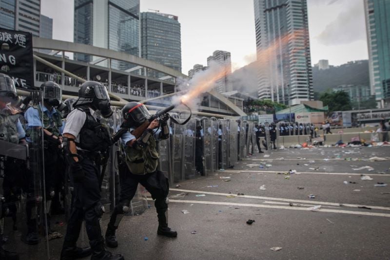 Hong Kong police force fire a tear gas shell to disperse the protestors in 2019