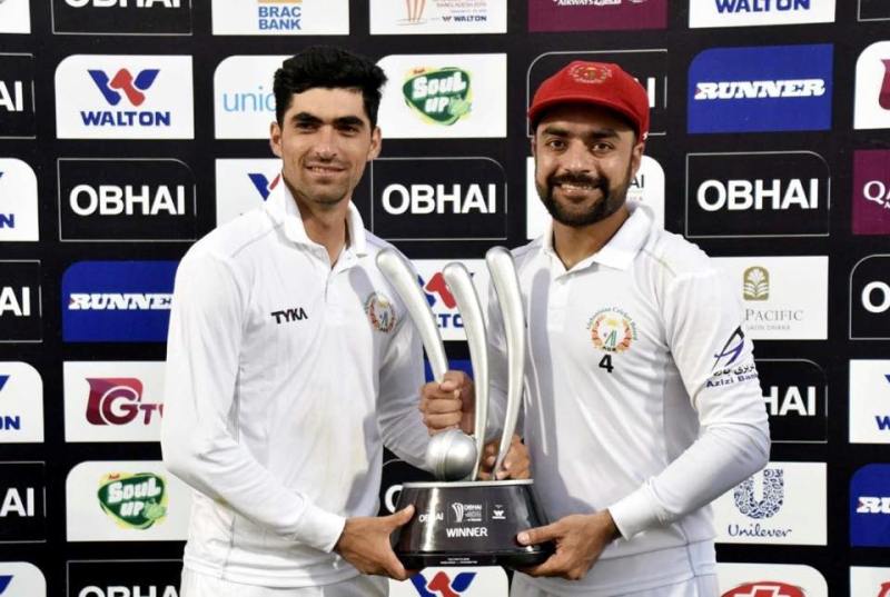 Ibrahim Zadran with Rashid Khan (right) on his test debut