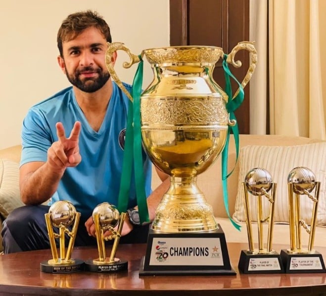 Iftikhar Ahmed posing with awards won in the National T20 Cup