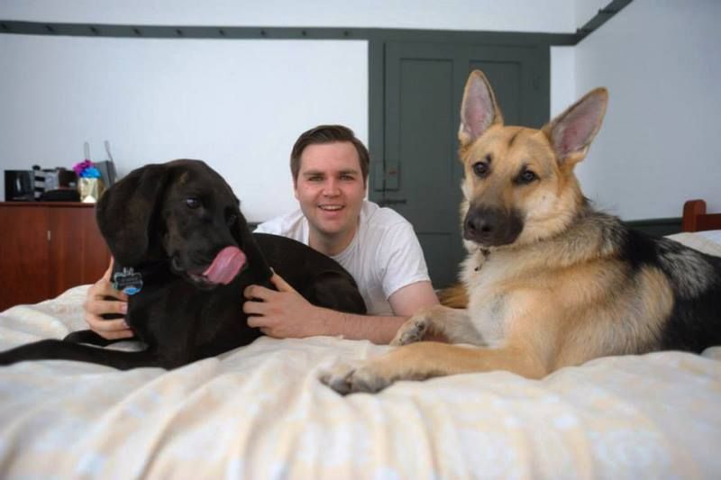 J. D. Vance posing for a photo with his pet dogs