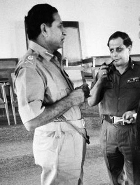 A photo of J. F. R. Jacob smoking his pipe