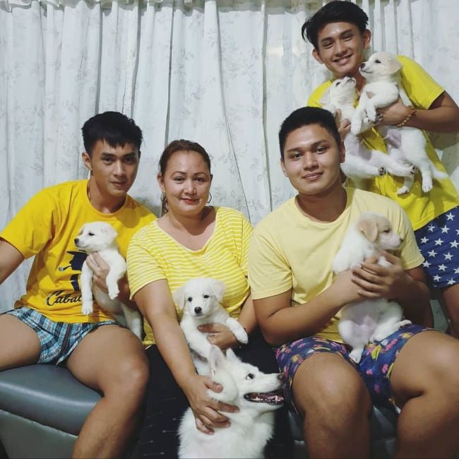 JM Ibarra and his family holding puppies