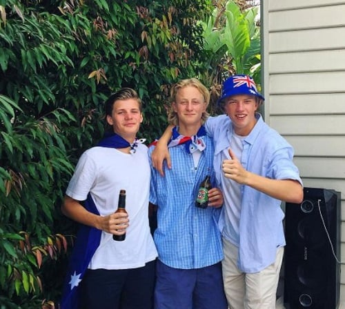 Jackson Warne holding a bottle of beer