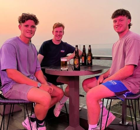 Jacob Bethell (extreme left) drinking beer during a party