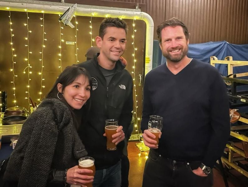 Jared Isaacman holding a mug of beer during a party