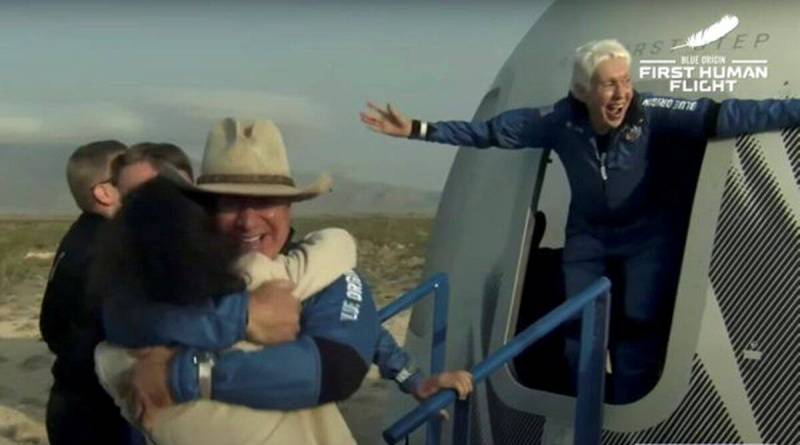 Jeff Bezos and pioneering female aviator Wally Funk emerge from their capsule after their flight aboard Blue Origin