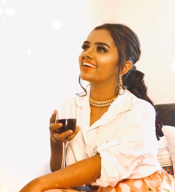 Janhavi holding a glass of wine