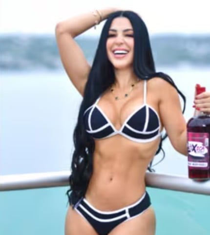 Jimena Araya while posing with an alcoholic beverage