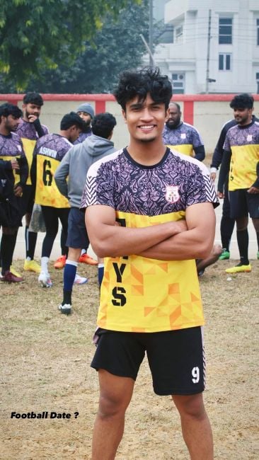 Joel Mathew wearing the football jersey of his team