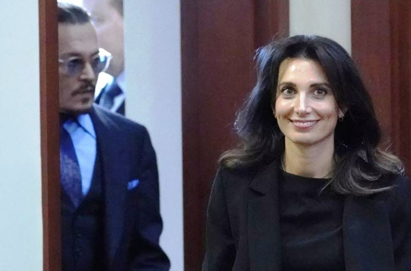 Joelle Rich smiling while walking ahead of Johnny Depp on May 2, 2022